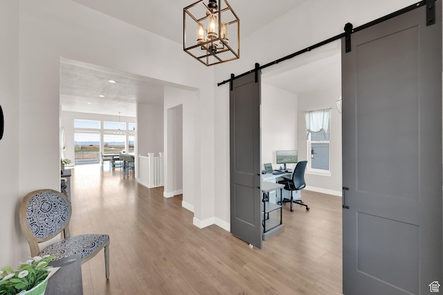 2266 S Betsys Way, Kaysville, UT 84037 - corridor featuring a barn door, a chandelier, light wood-style flooring, and an office area