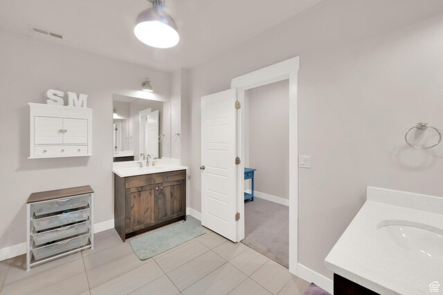 2266 S Betsys Way, Kaysville, UT 84037 - bathroom with two vanities, baseboards, and tile patterned flooring