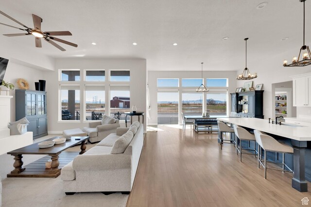 2266 S Betsys Way, Kaysville, UT 84037 - living area with light wood-style floors, a chandelier, recessed lighting, and ceiling fan