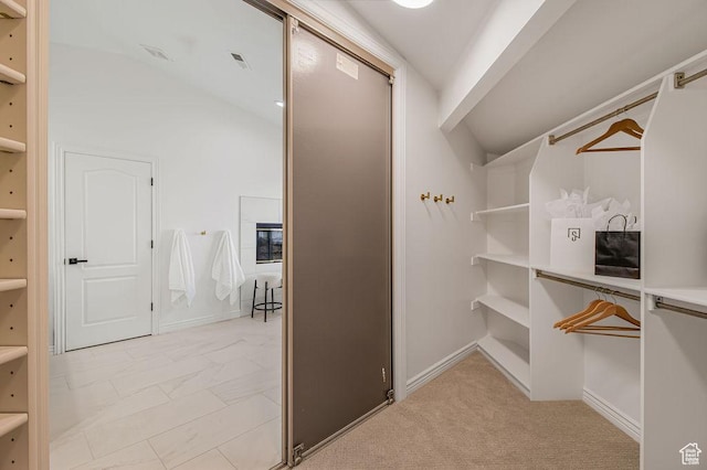 spacious closet with vaulted ceiling