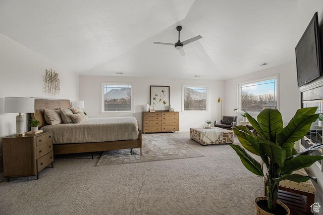 bedroom featuring a ceiling fan, vaulted ceiling, and light carpet