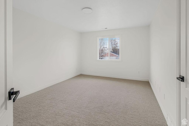 spare room with carpet flooring and baseboards