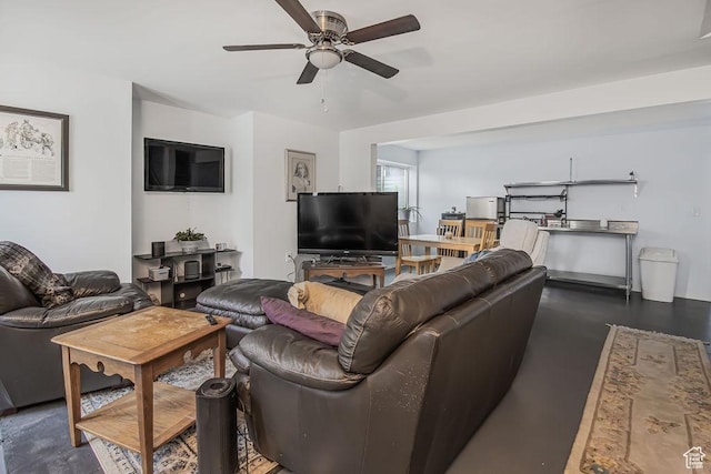 living room with finished concrete flooring and ceiling fan