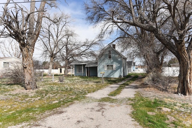 250 W Cherry St S, Grantsville, UT 84029 - view of front of property with driveway and a chimney