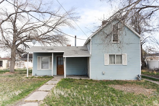 250 W Cherry St S, Grantsville, UT 84029 - view of front of home with a shingled roof, fence, and a front lawn