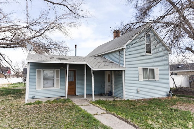 250 W Cherry St S, Grantsville, UT 84029 - view of front of home with a front yard, a shingled roof, and a chimney