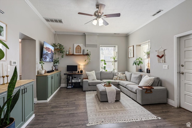 living area with visible vents, crown molding, ceiling fan, and dark wood-style flooring