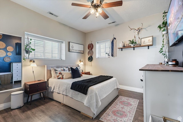 bedroom with wood finished floors, baseboards, and visible vents