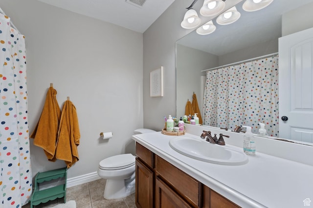 bathroom featuring visible vents, baseboards, toilet, tile patterned floors, and vanity