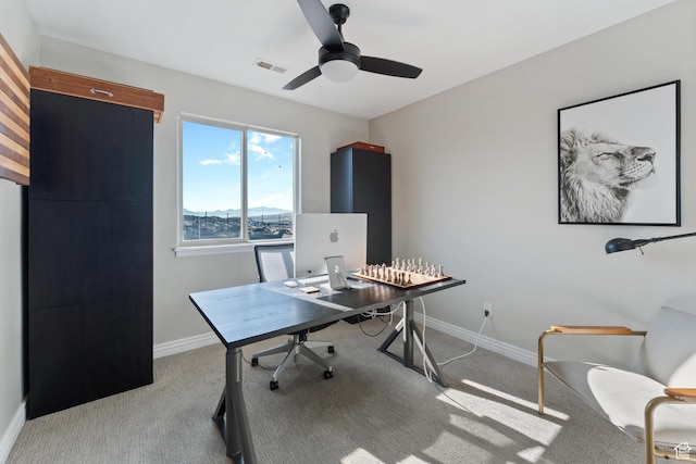 office area featuring baseboards, carpet floors, visible vents, and a ceiling fan