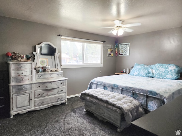 bedroom with baseboards, a ceiling fan, and dark colored carpet