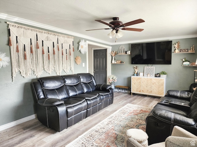 living room with wood finished floors, ceiling fan, and ornamental molding