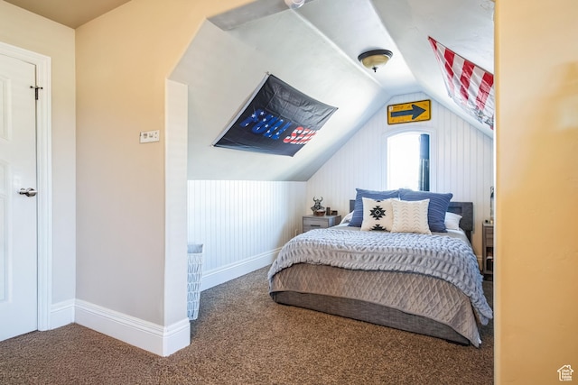 carpeted bedroom with baseboards and vaulted ceiling