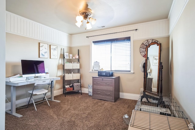 office area with carpet flooring, visible vents, baseboards, and ceiling fan
