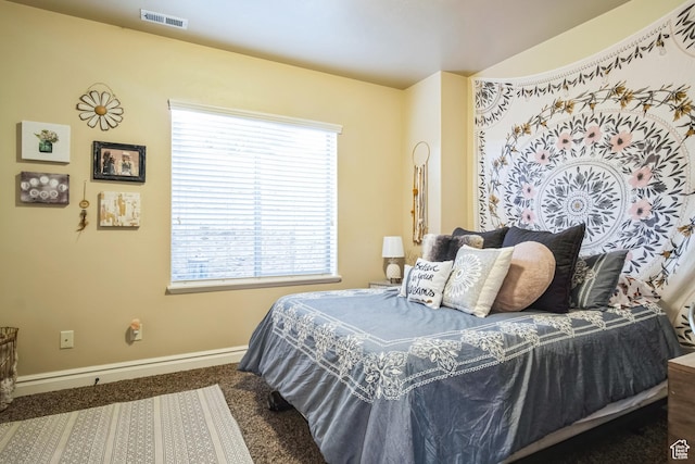 bedroom with baseboards, carpet flooring, and visible vents