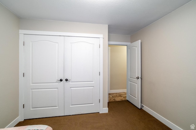 2164 S Alison Row, St George, UT 84790 - unfurnished bedroom featuring a closet, baseboards, and dark colored carpet