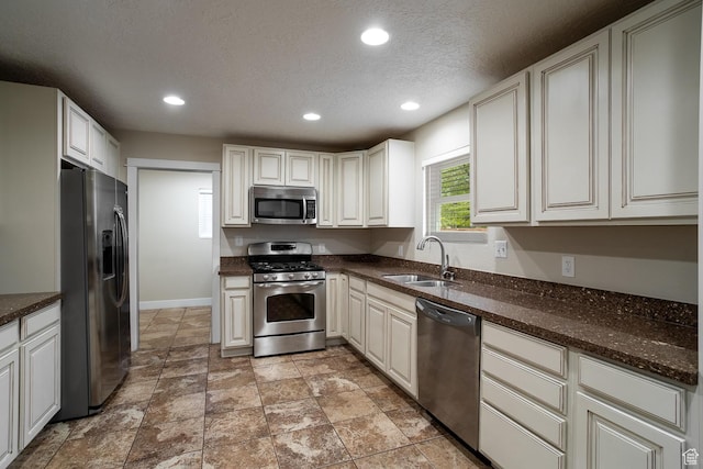 2164 S Alison Row, St George, UT 84790 - kitchen featuring a textured ceiling, baseboards, stainless steel appliances, recessed lighting, and a sink