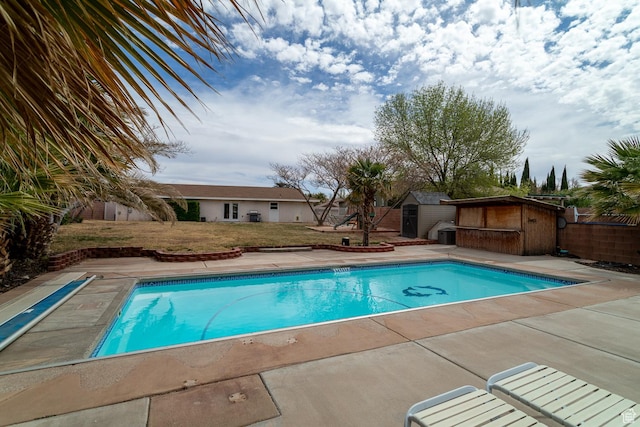 2164 S Alison Row, St George, UT 84790 - view of pool with a fenced in pool, a yard, an outdoor structure, and a storage shed
