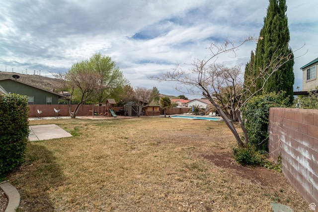 2164 S Alison Row, St George, UT 84790 - view of yard with a fenced backyard, a playground, a fenced in pool, and a patio