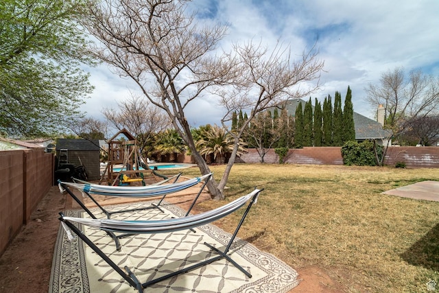 2164 S Alison Row, St George, UT 84790 - view of yard featuring a fenced backyard, an outdoor structure, and a playground