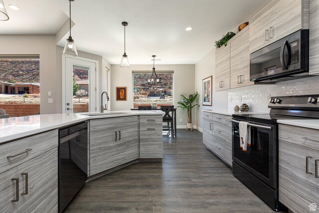 484 E Mohawk Dr, Kanab, UT 84741 - kitchen featuring light countertops, tasteful backsplash, a sink, modern cabinets, and black appliances