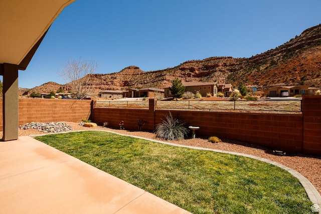 484 E Mohawk Dr, Kanab, UT 84741 - view of yard with a mountain view, fence private yard, and a patio area