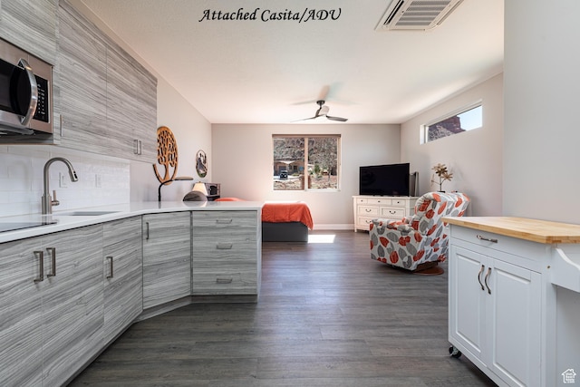 484 E Mohawk Dr, Kanab, UT 84741 - kitchen featuring stainless steel microwave, dark wood finished floors, a sink, visible vents, and a peninsula