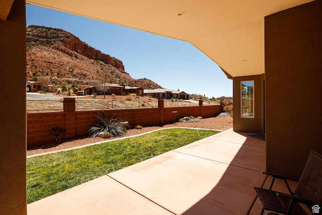 484 E Mohawk Dr, Kanab, UT 84741 - view of yard featuring a mountain view, fence, and a patio