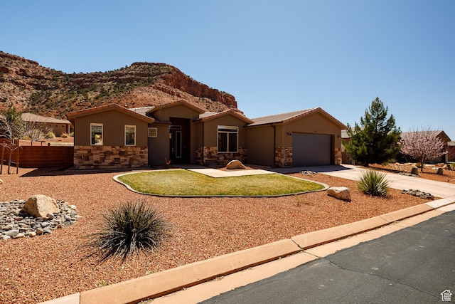 484 E Mohawk Dr, Kanab, UT 84741 - ranch-style house with stone siding, stucco siding, concrete driveway, and a garage