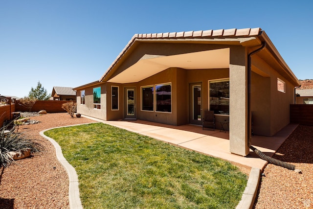 484 E Mohawk Dr, Kanab, UT 84741 - rear view of property featuring stucco siding, a fenced backyard, a yard, and a patio area
