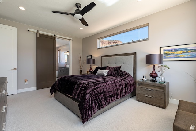 484 E Mohawk Dr, Kanab, UT 84741 - bedroom featuring baseboards, a barn door, connected bathroom, and light colored carpet
