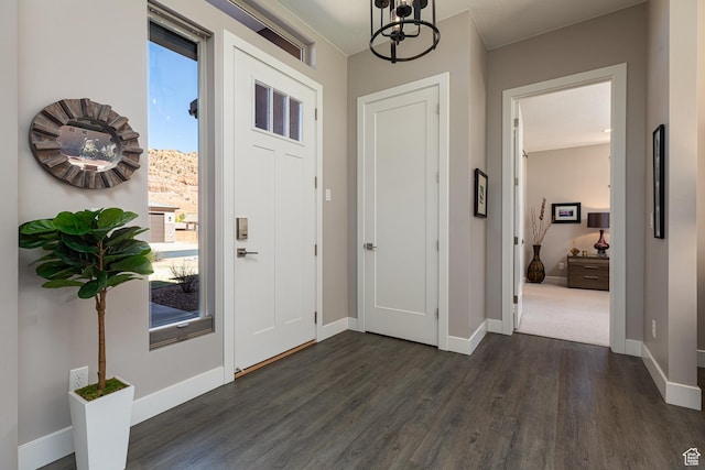 484 E Mohawk Dr, Kanab, UT 84741 - foyer entrance featuring dark wood-style floors, a notable chandelier, and baseboards