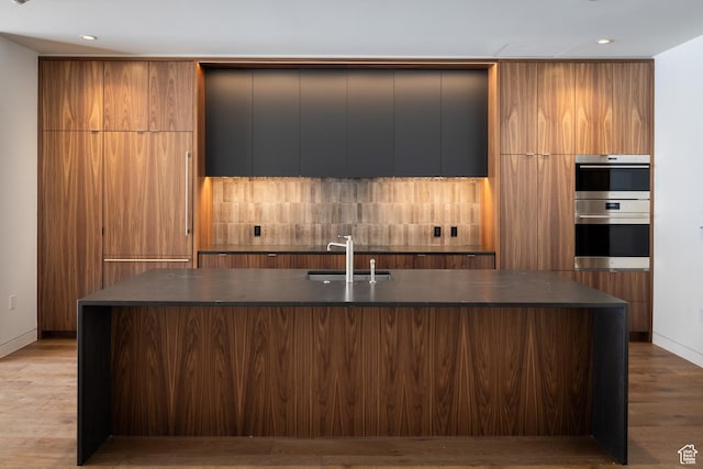 3267 W Deer Hollow Rd Unit 2402, Park City, UT 84060 - kitchen featuring modern cabinets, dark countertops, double oven, decorative backsplash, and recessed lighting