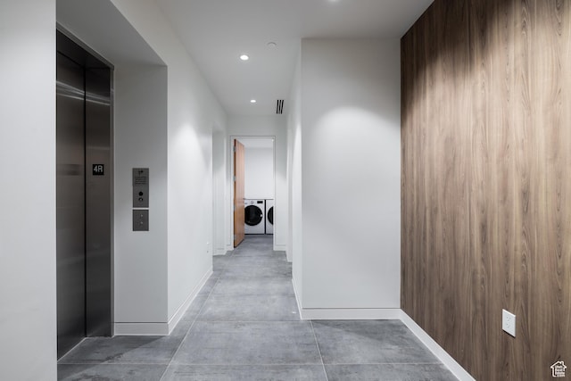 3267 W Deer Hollow Rd Unit 2402, Park City, UT 84060 - corridor with washing machine and dryer, elevator, recessed lighting, and concrete floors
