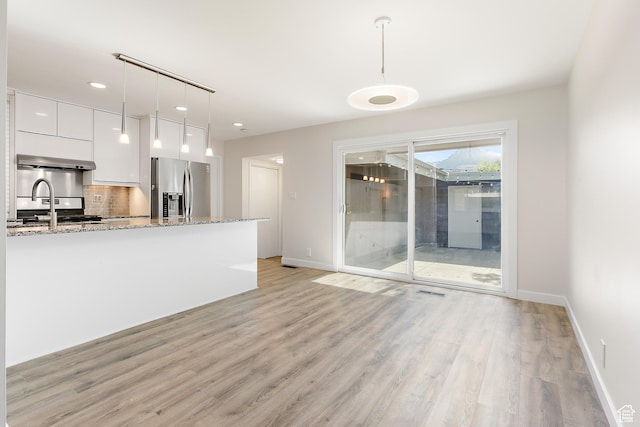 851 E Three Fountains Dr Unit 240, Murray, UT 84107 - unfurnished living room with baseboards, a sink, light wood-style flooring, and recessed lighting