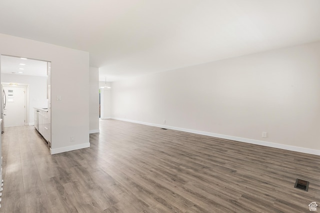851 E Three Fountains Dr Unit 240, Murray, UT 84107 - unfurnished room featuring baseboards, wood finished floors, and visible vents
