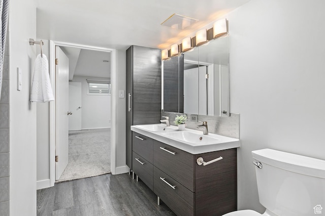 851 E Three Fountains Dr Unit 240, Murray, UT 84107 - full bath featuring a sink, decorative backsplash, wood finished floors, and toilet