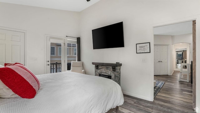 1138 S Meadow Fork Rd E Unit 3, Provo, UT 84606 - bedroom with wood finished floors, baseboards, arched walkways, and a stone fireplace