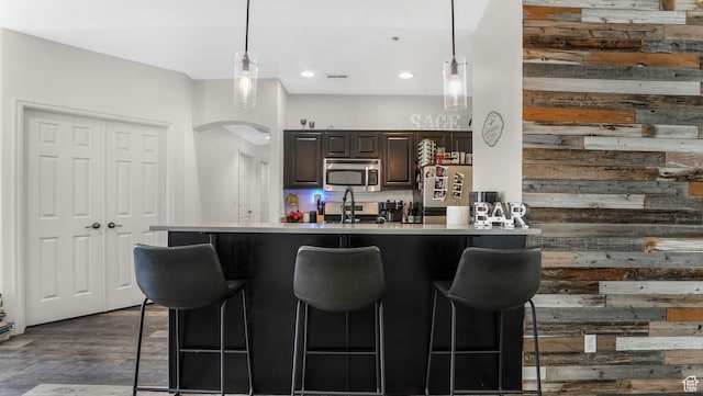 1138 S Meadow Fork Rd E Unit 3, Provo, UT 84606 - kitchen with stainless steel appliances, a kitchen breakfast bar, arched walkways, pendant lighting, and light countertops