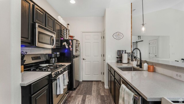 1138 S Meadow Fork Rd E Unit 3, Provo, UT 84606 - kitchen featuring appliances with stainless steel finishes, a sink, dark wood-type flooring, a peninsula, and hanging light fixtures