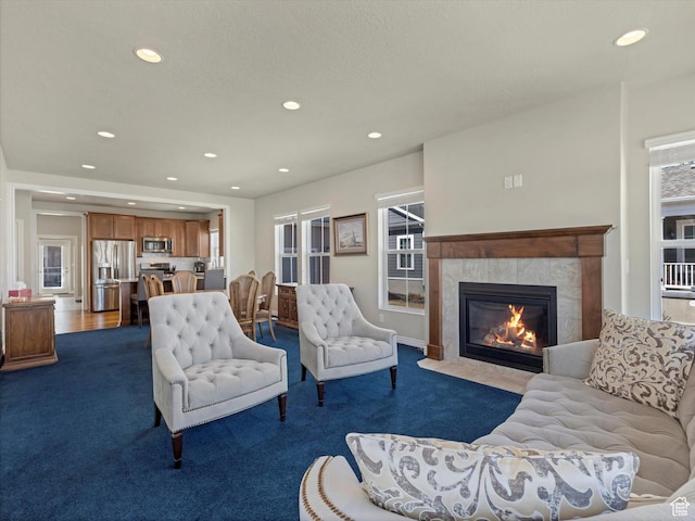 11126 S Kiwano Way S, Jordan, UT 84009 - living room with a fireplace, dark colored carpet, and recessed lighting