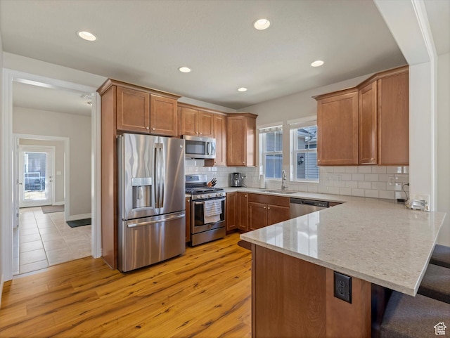 11126 S Kiwano Way S, Jordan, UT 84009 - kitchen with a sink, plenty of natural light, a peninsula, and appliances with stainless steel finishes