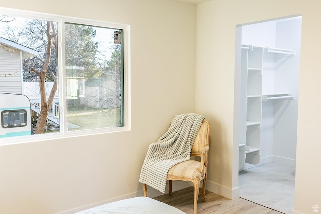 sitting room featuring baseboards and wood finished floors