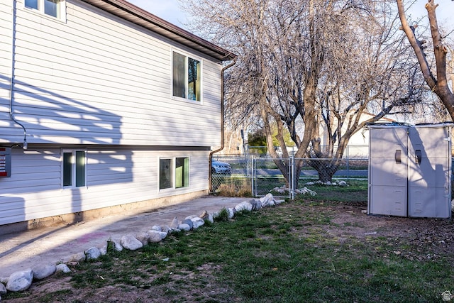 view of yard with an outdoor structure, a gate, and fence