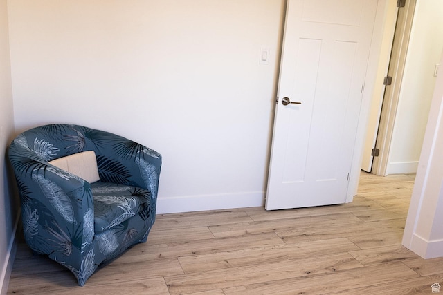 living area with light wood finished floors and baseboards
