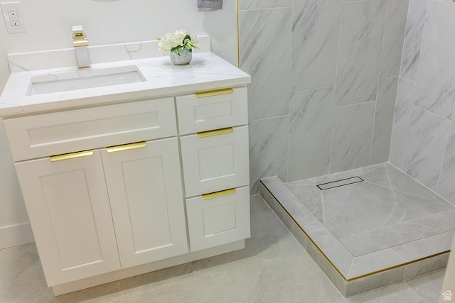 bathroom featuring a shower and vanity