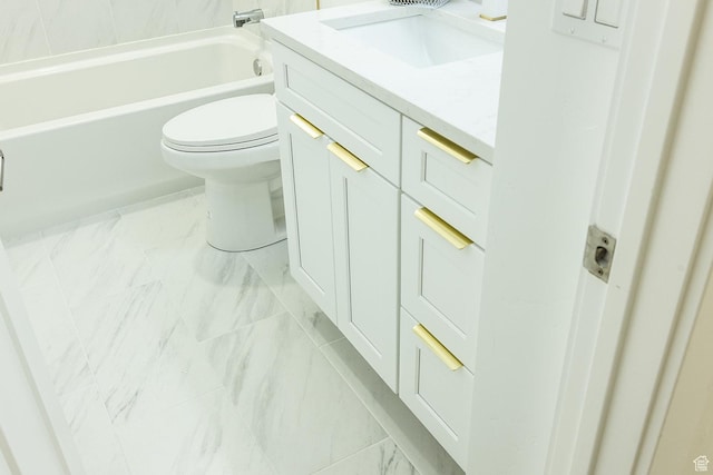 full bath with marble finish floor, toilet, a bathtub, and vanity