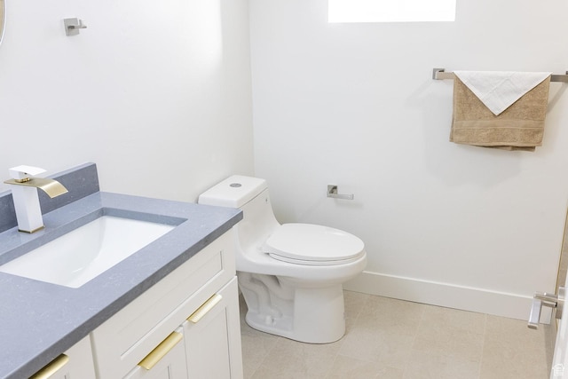 half bathroom with toilet, vanity, and baseboards