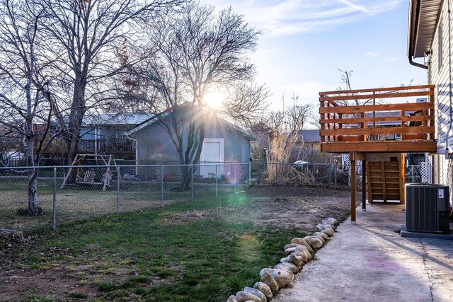 view of yard with a fenced backyard, stairway, central AC unit, and a deck