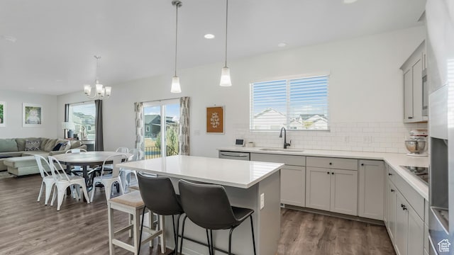 442 Doubleday St, Mapleton, UT 84664 - kitchen featuring a kitchen breakfast bar, dark wood finished floors, decorative backsplash, a sink, and a notable chandelier